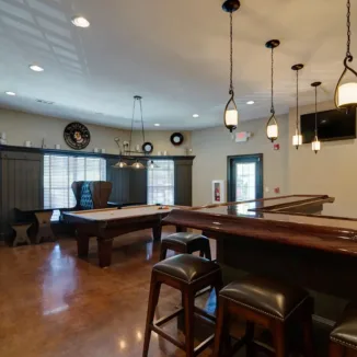 resident game room with billiard table and a bar