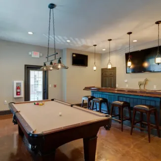 resident game room with billiards table and a bar